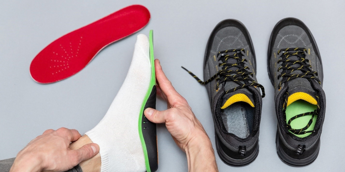 A person carefully places a shoe onto a shoe pad for organization and protection.
